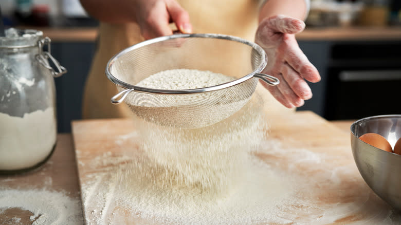 sifting flour over board