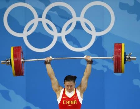 Cao Lei of China sets an Olympic record of 154kg in the women's 75kg Group A weightlifting clean & jerk competition at the Beijing 2008 Olympic Games August 15, 2008. REUTERS/Yves Herman/Files