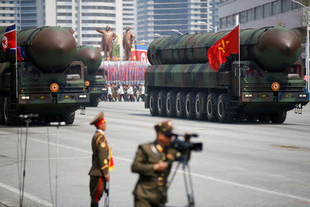 FILE PHOTO: Intercontinental ballistic missiles (ICBM) are driven past the stand with North Korean leader Kim Jong Un and other high ranking officials during a military parade marking the 105th birth anniversary of country's founding father Kim Il Sung, in Pyongyang April 15, 2017. REUTERS/Damir Sagolj/File Photo