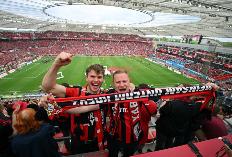 Leverkusen fans celebrate the championship following the German Bundesliga soccer match between Bayer Leverkusen and FC Augsburg at BayArena. David Inderlied/dpa