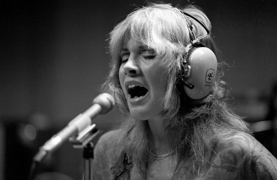 Photo of Stevie Nicks and FLEETWOOD MAC, Stevie Nicks singing in the recording studio, wearing headphones (Photo by Fin Costello/Redferns)