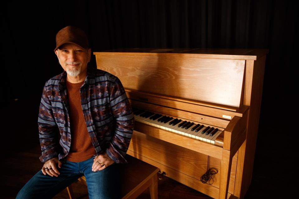 Makky Kaylor sits in front a Baldwin Piano formerly belonging to his mother that now sits in the Memorial Building in Columbia, Tenn. on Mar. 15, 2023. in Columbia, Tenn. on Mar. 15, 2023. 