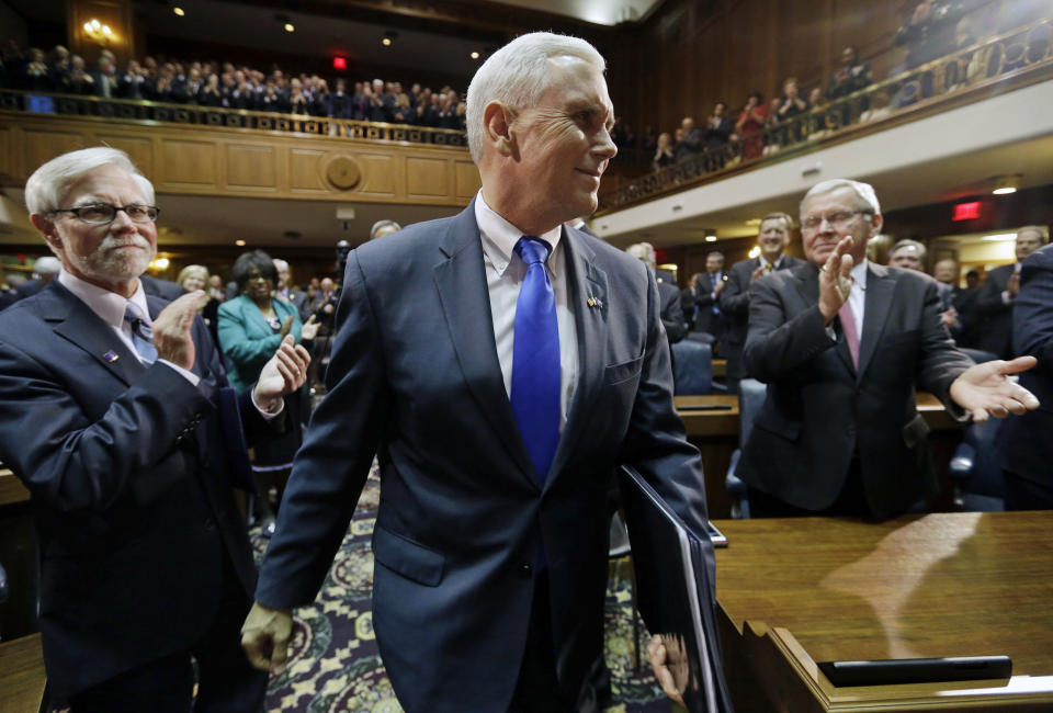 FILE - Indiana Gov. Mike Pence walks to the podium to give his State of the State address to a joint session of the Legislature at the Statehouse, Jan. 14, 2014, in Indianapolis. As Mike Pence approaches a likely 2024 run for president, he's opening up to audiences about the parts of his career before he served as Donald Trump's vice president. He hopes his 12 years in Congress and four years as Indiana governor will project the record of a conservative fighter. (AP Photo/Darron Cummings, File)