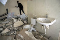 A man examines a newly built natal center damaged by shelling by Azerbaijan's artillery in Stepanakert, the separatist region of Nagorno-Karabakh, Wednesday, Oct. 28, 2020. Nagorno-Karabakh officials said Azerbaijani forces hit Stepanakert, the region's capital, and the nearby town of Shushi with the Smerch long-range multiple rocket systems, killing one civilian and wounding two more. (AP Photo)