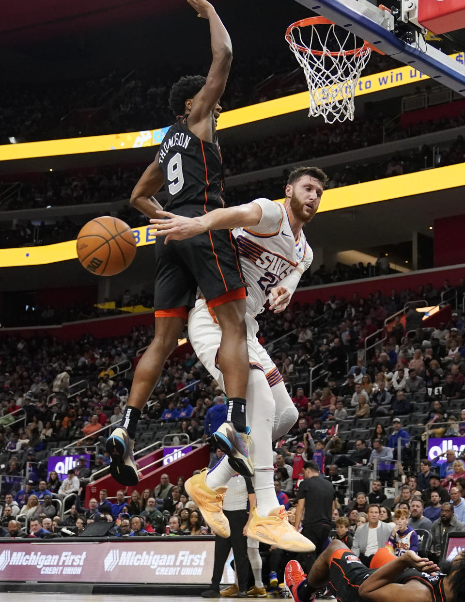 Phoenix Suns center Jusuf Nurkic (20) passes around Detroit Pistons forward Ausar Thompson (9) during the second half of an NBA basketball game, Sunday, Nov. 5, 2023, in Detroit. (AP Photo/Carlos Osorio)