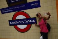 A passenger takes a selfie at Southgate Underground Station, temporarily renamed as 'Gareth Southgate' in honour of England soccer team manager Gareth Southgate, is seen in London, Britain July 16, 2018. REUTERS/Hannah McKay
