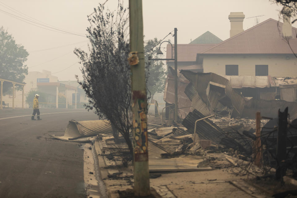 Firefighters inspect fire damage in Cobargo, NSW.