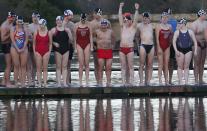 Swimmers wait to dive into the Serpentine river on Christmas Day in Hyde Park, central London December 25, 2013. For over 100 years, swimmers have taken part in the Christmas Day "Peter Pan" swim in the Serpentine. REUTERS/Suzanne Plunkett (BRITAIN - Tags: SOCIETY SPORT SWIMMING)