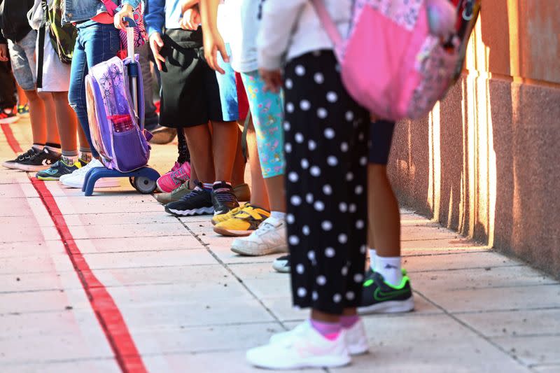 Pupils wait in a queue upon arrival on the first day of school amid the coronavirus disease (COVID-19) outbreak in Madrid