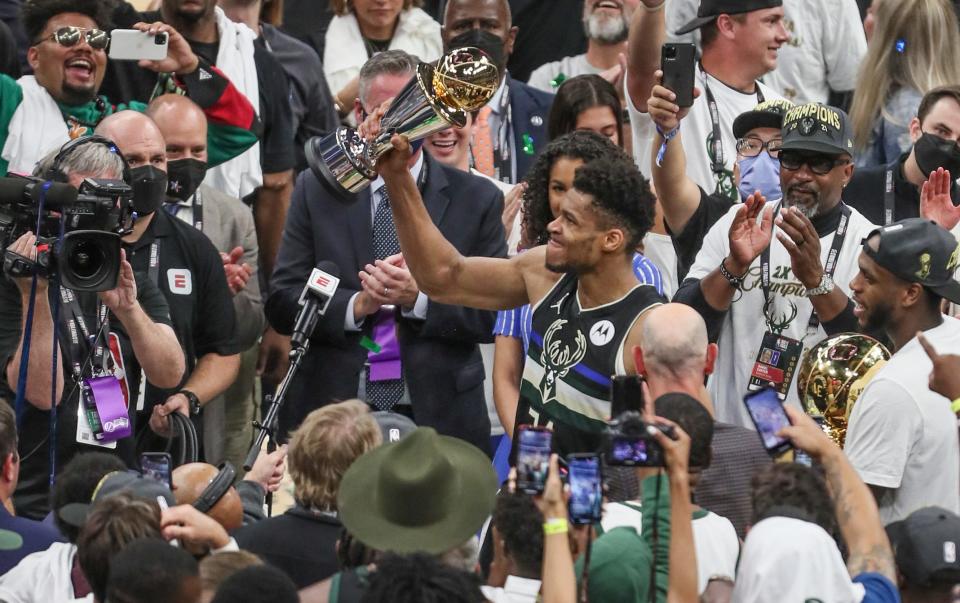 MVP Milwaukee Bucks forward Giannis Antetokounmpo (34) holds after the 105-98 win over the Phoenix Suns in Game 6 of the NBA Finals Tuesday, July 20, 2021, at Fiserv Forum in Milwaukee.