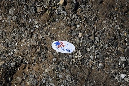 A discarded "I Voted" sticker is pictured outside a rural polling site on Super Tuesday in Stillwater, Oklahoma March 1, 2016. REUTERS/Nick Oxford/Files