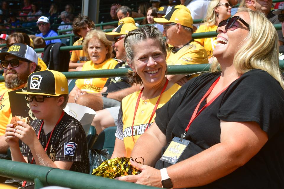 Emily Carter, left and Sarah Tabor share a laugh prior to a Little League World Series game between Southeast Region and the Metro Region on Friday, Aug. 18, 2023 in South Williamsport, Pa. Carters husband Mark is a coach for the team and her son Nash pitches. Mandatory Credit: Ralph Wilson-The Tennessean