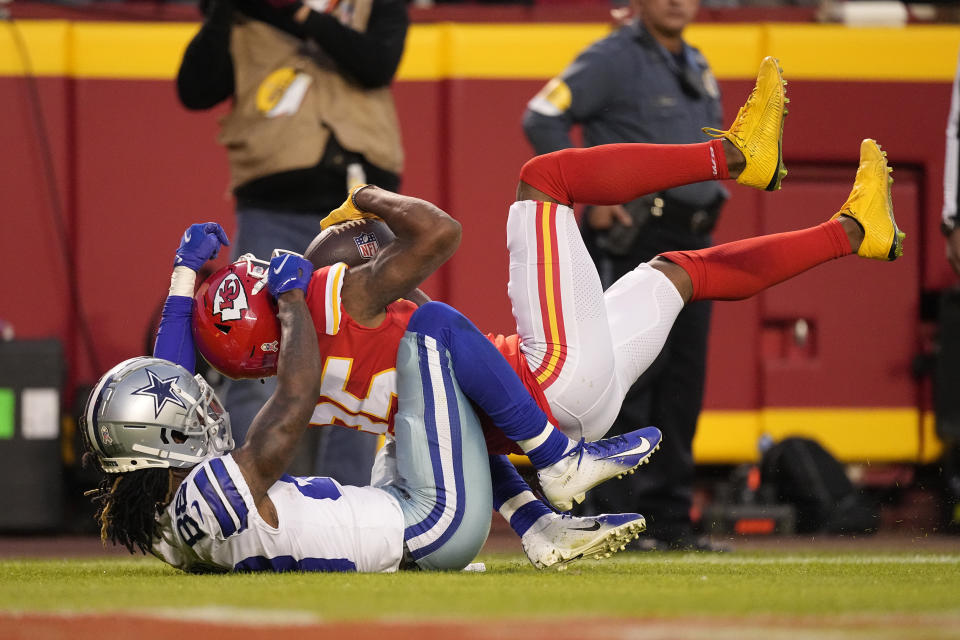 Kansas City Chiefs cornerback Charvarius Ward, right, intercepts a pass intended for Dallas Cowboys wide receiver CeeDee Lamb (88) during the first half of an NFL football game Sunday, Nov. 21, 2021, in Kansas City, Mo. (AP Photo/Charlie Riedel)