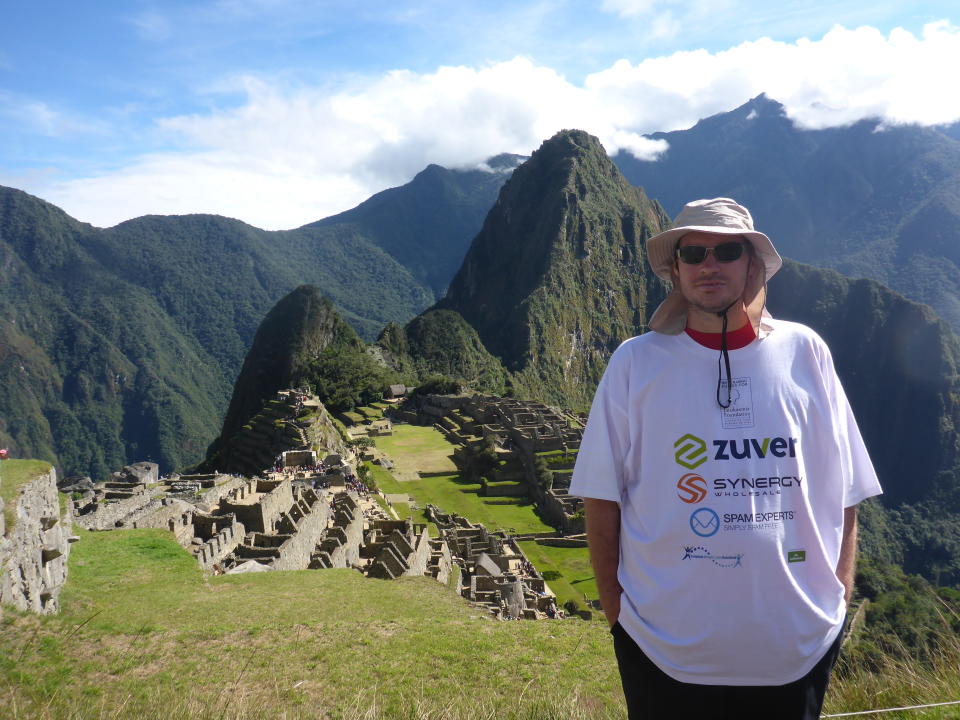 Craig Marchant stands on a mountainous range. 