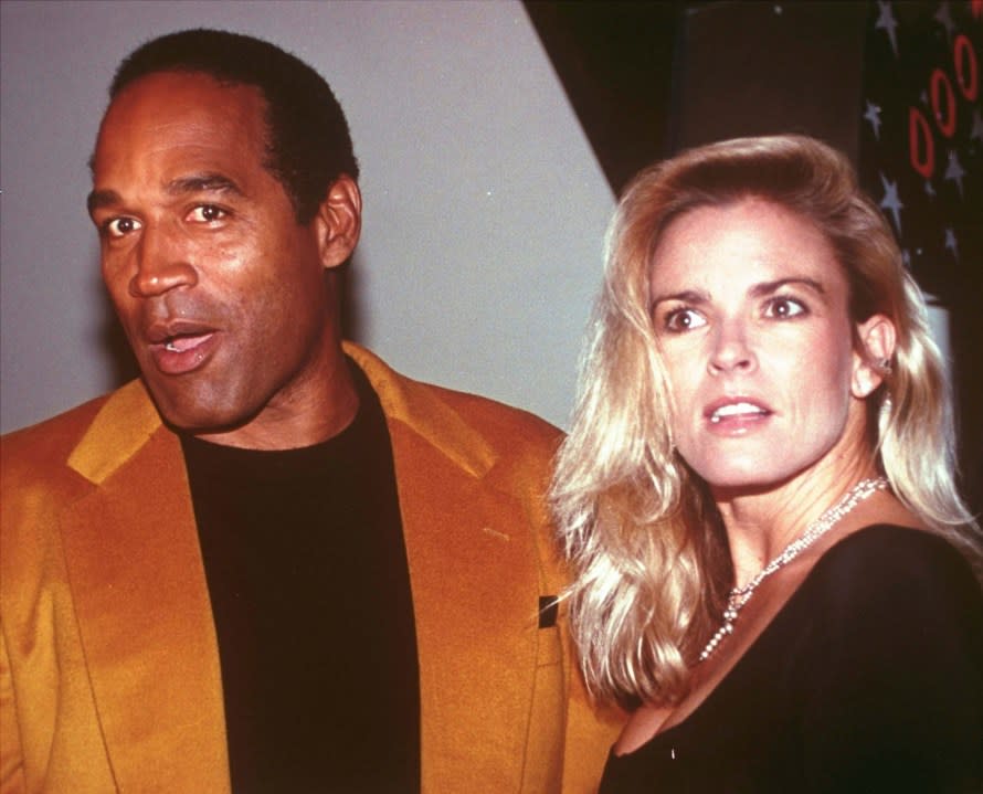 FILE - O.J. Simpson and his wife, Nicole Brown Simpson, arrive for the opening of the Harley-Davidson Cafe in New York on Oct. 19, 1993. Simpson, the decorated football superstar and Hollywood actor who was acquitted of charges he killed Nicole Brown Simpson and her friend but later found liable in a separate civil trial, has died. He was 76. (AP Photo/Paul Hurschmann, File)