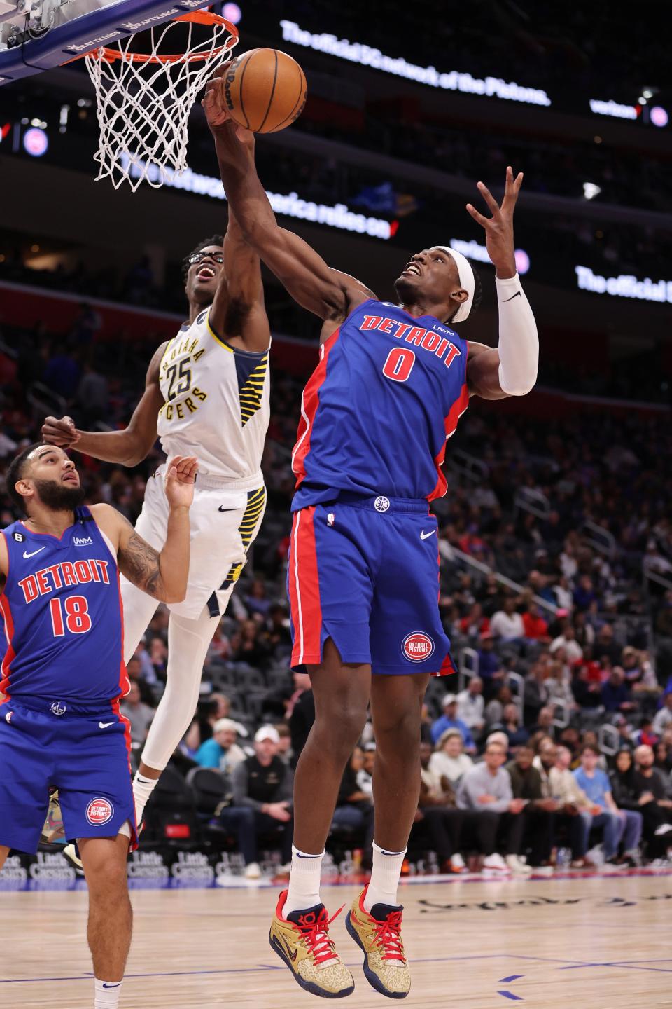 Jalen Duren of the Detroit Pistons battles for a rebound against Jalen Smith of the Indiana Pacers during the first half at Little Caesars Arena in Detroit on Saturday, March 11, 2023.