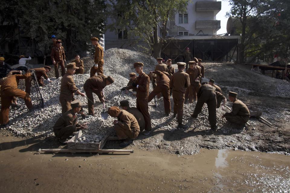 FILE - North Korean construction workers labor in the Mansudae area of Pyongyang, North Korea, Oct. 11, 2011. As the war in Ukraine stretches into its seventh month, North Korea is hinting at its interest in sending construction workers to help rebuild Russian-occupied territories in the country's east.(AP Photo/David Guttenfelder, File)