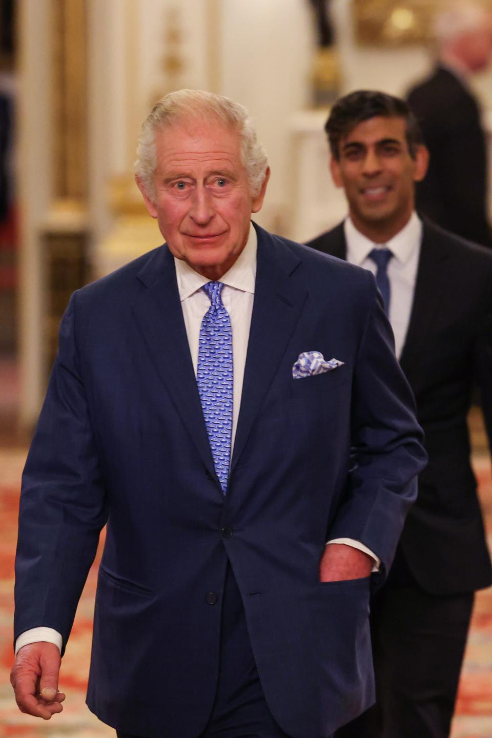 Britain's King Charles III (L) followed by Britain's Prime Minister Rishi Sunak (Getty Images)