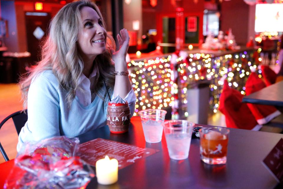 Kelly Morrell talks with friends while enjoying a Holiday Spiked Chai cocktail at Ponyboy. The bar's Miracle pop-up features themed food and cocktails for the Christmas season.