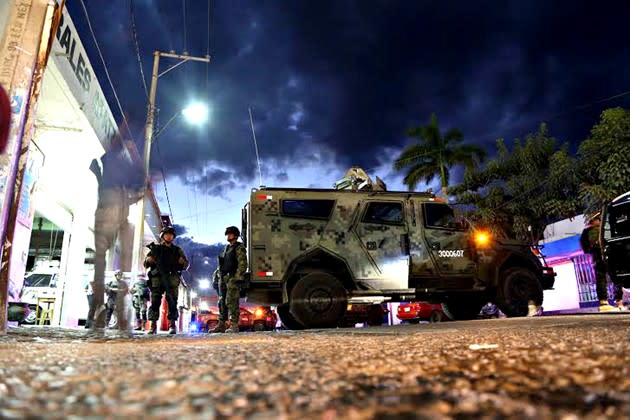 Mexican marines and soldiers guard the surroundings of the morgue where the alleged corpse of Nazario Moreno was stored in Apatzingan, Michoacan, Mexico, in 2014. (Enrique Castro / AFP / Getty)