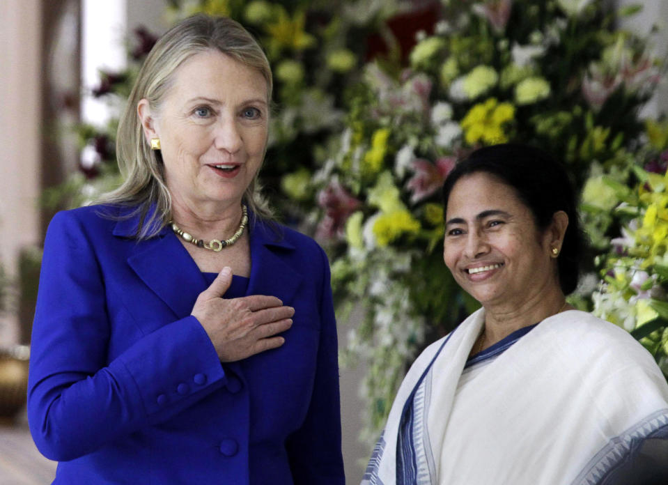 U.S. Secretary of State Hillary Rodham Clinton, left, gestures beside West Bengal Chief Minister Mamata Banerjee before a meeting in Kolkata, India, Monday, May 7, 2012. Clinton met with Mamata Banerjee, a key partner of India's ruling coalition who has stymied government efforts to lift restrictions on foreign-owned investments in the country. (AP Photo/Bikas Das)