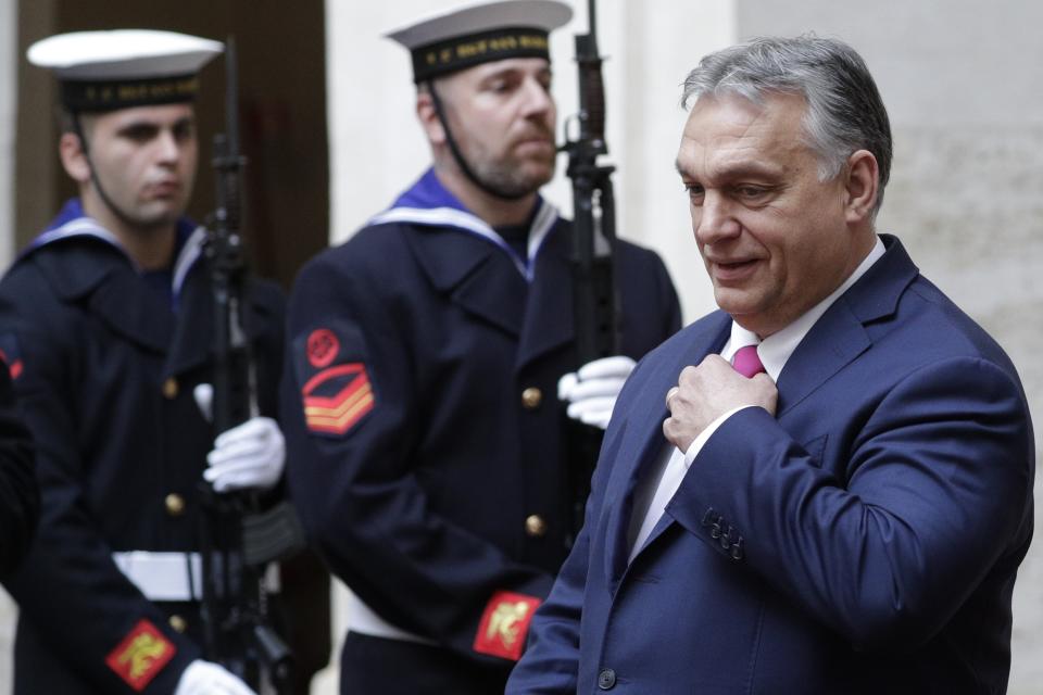 Hungarian Premier Viktor Orban reviews the honor guard as he arrives to meet Italian Premier Giuseppe Conte, in Rome, Monday, Feb. 3, 2020. (AP Photo/Andrew Medichini)