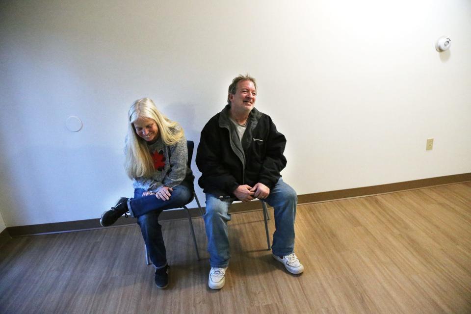 Jeff and Tami Sandler smile in their new apartment on Dec. 11, 2023. The couple had been homeless for 10 months and lived in a tent in the woods of Sanford, Maine.