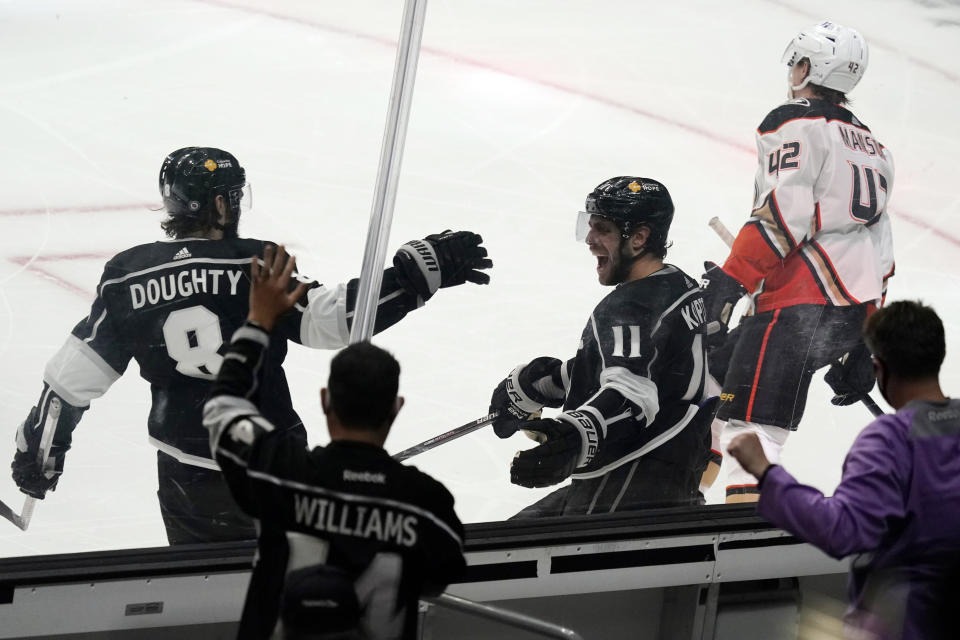 Los Angeles Kings center Anze Kopitar (11) celebrates his goal with Drew Doughty (8) during the second period of an NHL hockey game against the Anaheim Ducks on Tuesday, April 20, 2021, in Los Angeles. (AP Photo/Marcio Jose Sanchez)