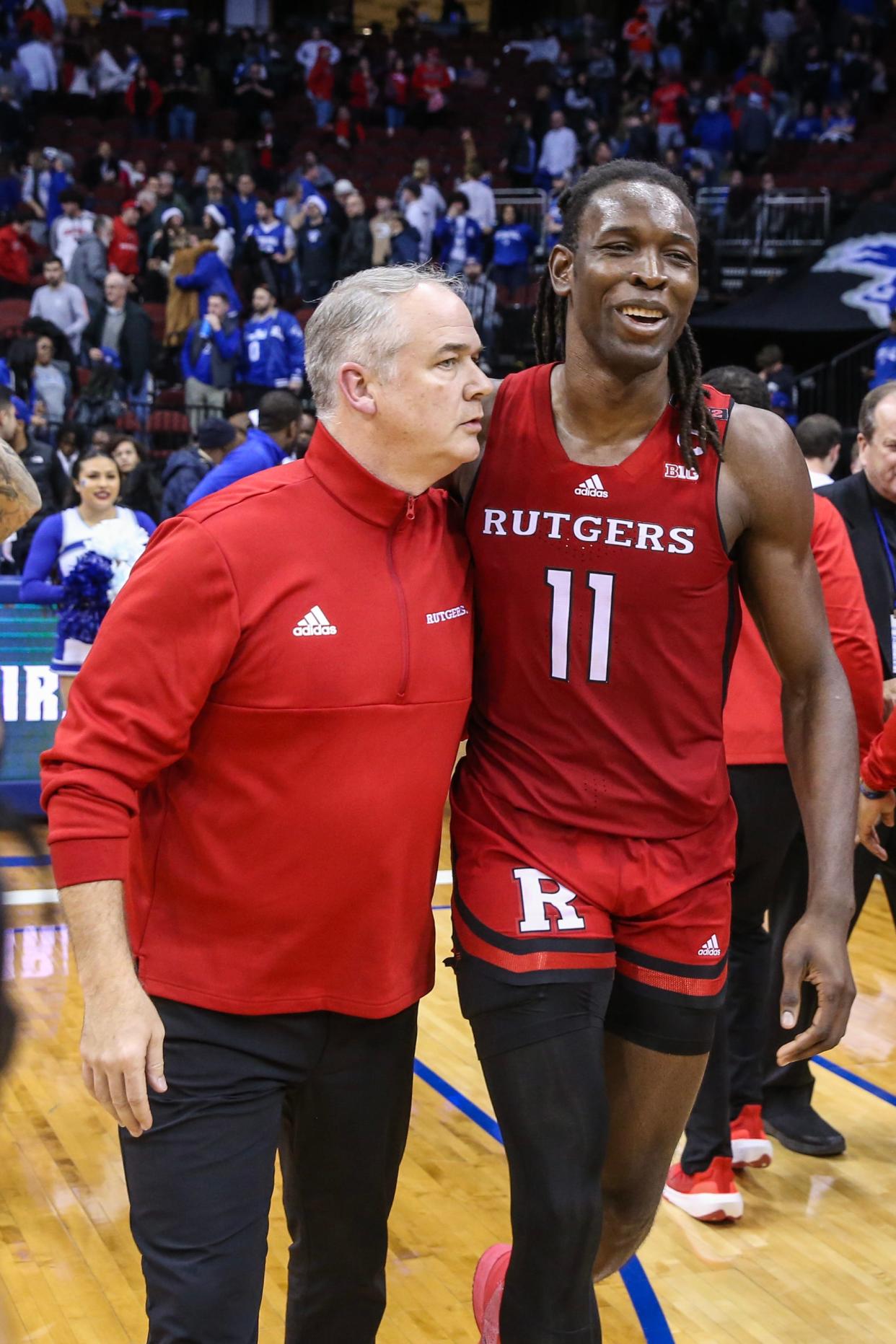 Rutgers Scarlet Knights center Clifford Omoruyi (11) walks off with head coach Steve Pikiell after defeating the Seton Hall Pirates