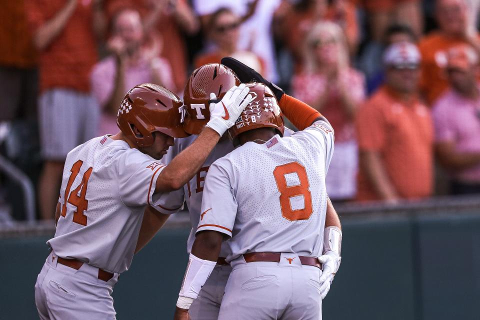 From left, Murphy Stehly, Ivan Melendez and Dylan Campbell celebrate a home run by Melendez against Air Force in the NCAA Austin Regional on June 5.