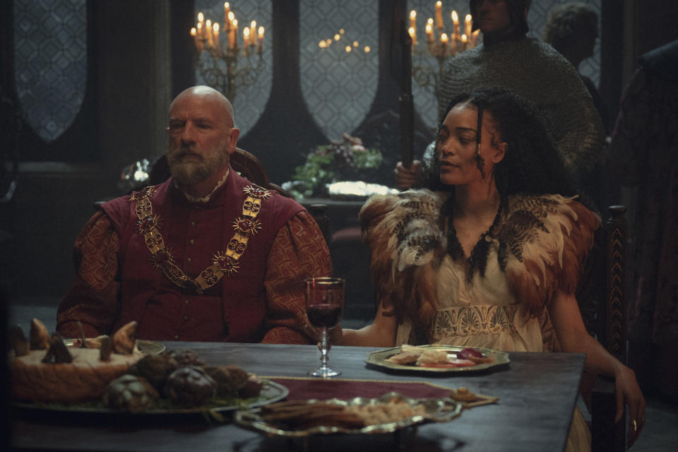 Spymaster Dijkstra and mage Philippa sit at a dining table