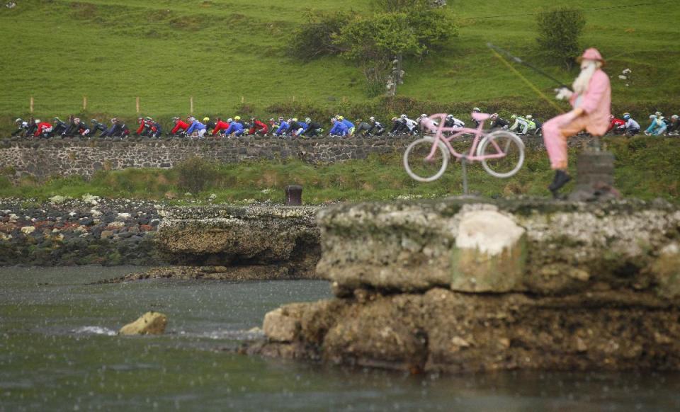 The main Peloton make their way along the North Antrim coast during stage two of the Giro d'Italia cycle race in Northern Ireland, Saturday, May 10, 2014. (AP Photo/Peter Morrison)