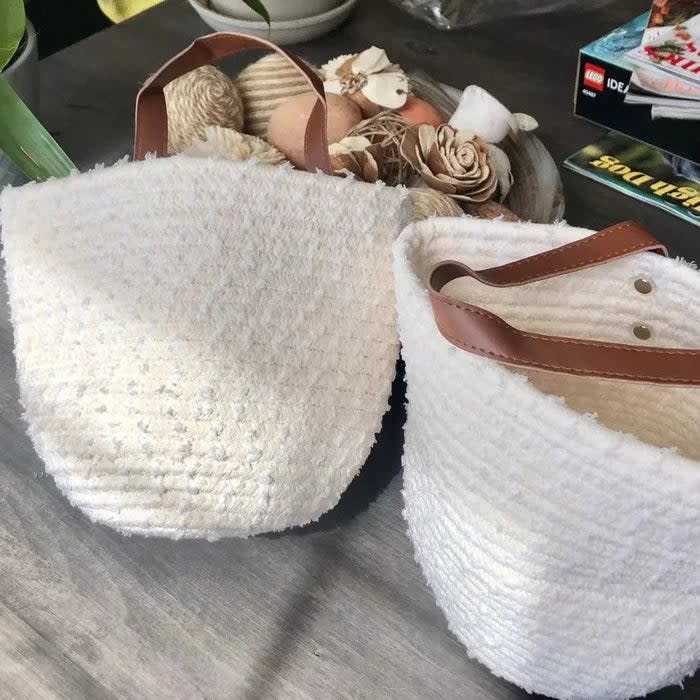 Reviewer's photo of two white baskets with brown straps