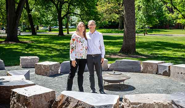 Mark Freeland, right, succeeded Noodin as director of the Electa Quinney Institute, which supports Native students and research on Indigenous languages and culture. The two stand in a fire circle in front of Merrill Hall in 2022.