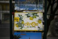 A rack of posters are for sale during the 90th edition of the Lemon Festival in Menton, France on Friday, March 1, 2024. Menton was once a leading lemon-growing region in Europe. (AP Photo/Daniel Cole)