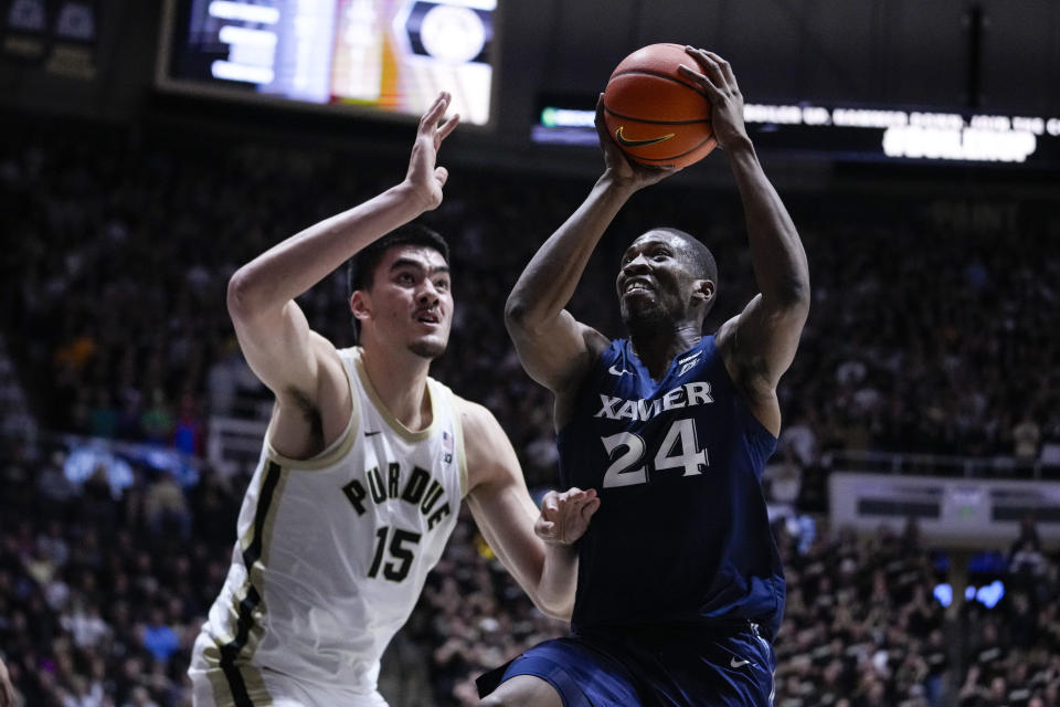 Xavier forward Abou Ousmane (24) shoots over Purdue center Zach Edey (15) during the first half of an NCAA college basketball game in West Lafayette, Ind., Monday, Nov. 13, 2023. (AP Photo/Michael Conroy)