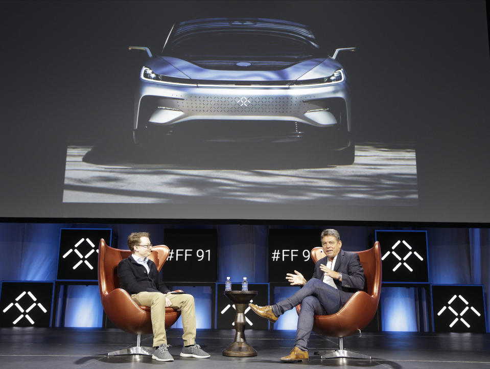 Tim Higgins, of the Wall Street Journal, left, and Dr. Carsten Breitfeld, Global CEO of Faraday Future, participate in the technology panel "Faraday's Future: Transforming The Road of Future Mobility," at the AutoMobility LA auto show at the Los Angeles Convention Center in Los Angeles Tuesday, Nov. 19, 2019. (AP Photo/Damian Dovarganes)