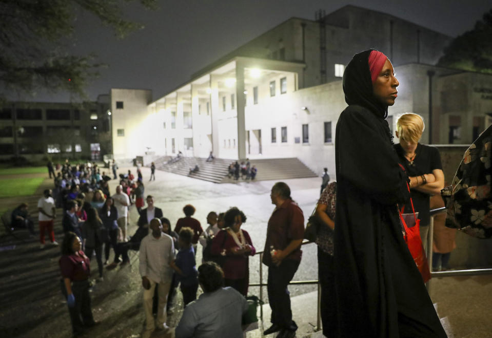 "I can remember when I did not have the right to vote," said Nancy Glenn Griesinger, second from right, when asked why she waited so long in line to vote Tuesday, March 3, 2020, at Texas Southern University in Houston. After 10 p.m., a line of people still stretched out of the Robert James Terry Library as they waited to cast their votes. (Jon Shapley/Houston Chronicle via AP)