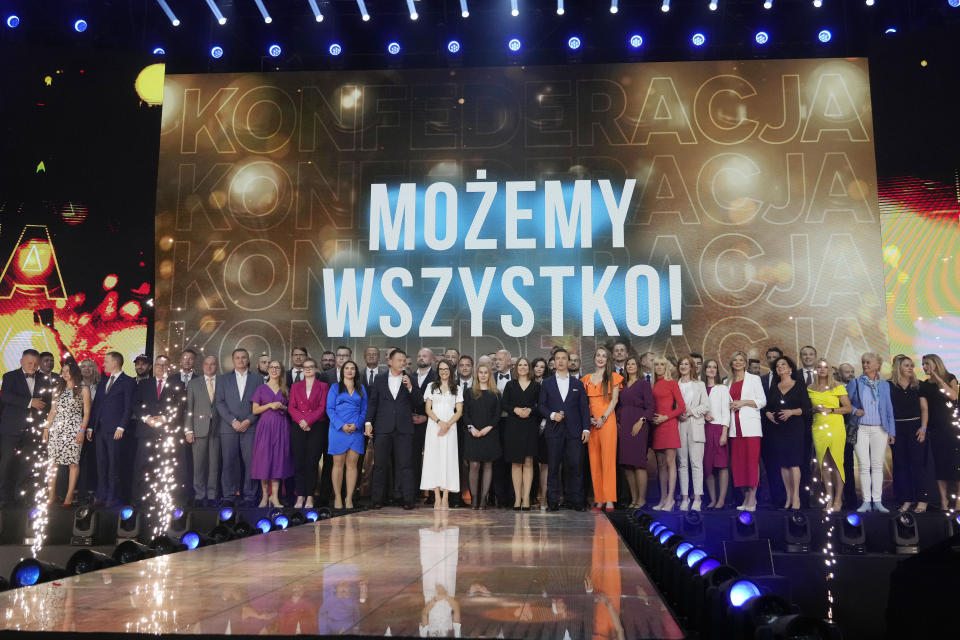 Slawomir Mentzen, centre left, and Krzysztof Bosak, centre right, the co-leaders of the hard right Confederation party, present their party slogan "Mozemy Wszystko!" (We Can Do Anything) at a convention in Katowice, Poland, on Saturday, Sept. 23, 2023. Confederation has been growing in popularity, especially among young men. The party has been riding a wave of growing support for far-right parties across Europe, and polls show it could increase its presence in parliament in a national election Oct. 15. No matter how they do on election day, the party has already done a lot to push the government to take a more confrontational stance to Ukraine, which is fighting for its survival against Russia. (AP Photo/Czarek Sokolowski)