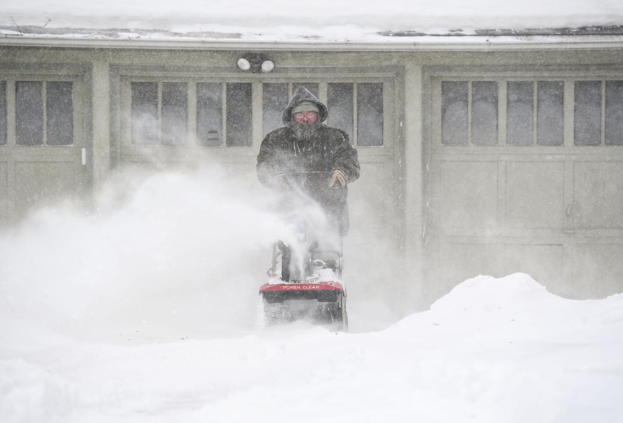David Dailey uses a snowblower as falling snow blusters around him on Wednesday, February 22, 2023, in Sioux Falls.