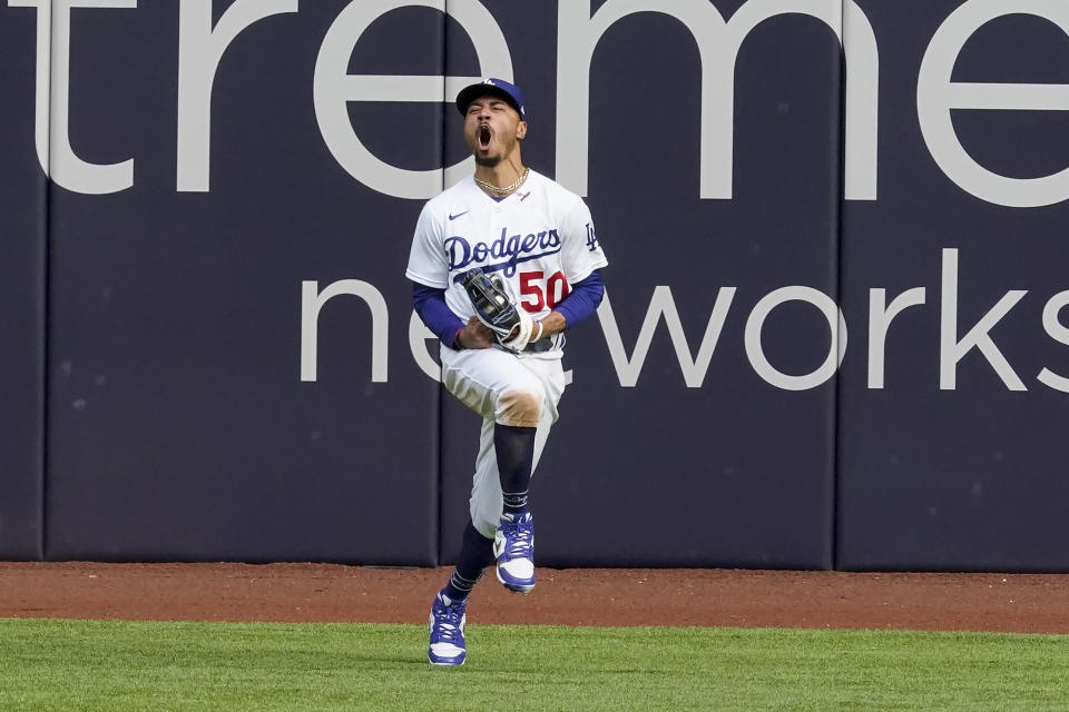 Los Angeles Dodgers right fielder Mookie Betts celebrates after robbing Atlanta Braves' Marcell Ozuna of a home during the fifth inning in Game 6 of a baseball National League Championship Series Saturday, Oct. 17, 2020, in Arlington, Texas. (AP Photo/Tony Gutierrez)