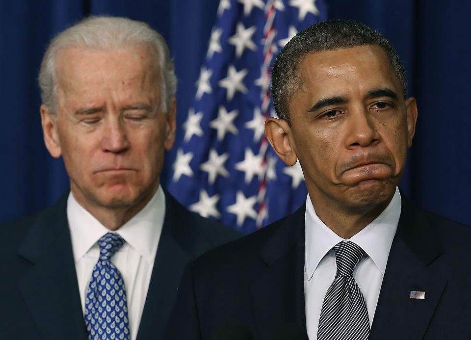 <p>President Barack Obama (R), is flanked by Vice President Joe Biden (L) before signing an executive order designed to tackle gun control, on January 16, 2012 in Washington, DC. One month after a massacre that left 20 school children and 6 adults dead in Newtown, Connecticut, the president unveiled a package of gun control proposals that include universal background checks and bans on assault weapons and high-capacity magazines. (Mark Wilson/Getty Images) </p>