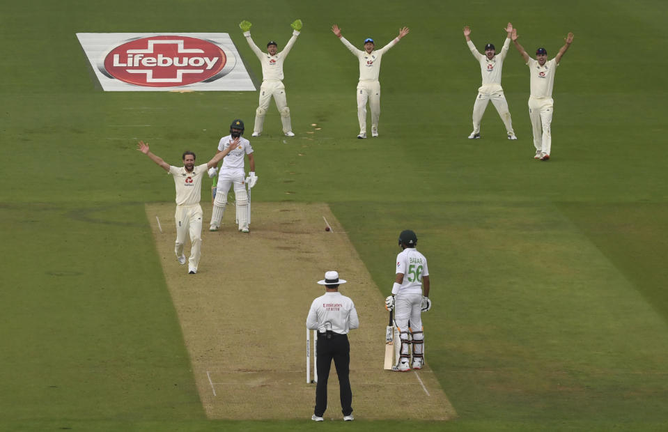 England's Chris Woakes, left, and teammates appeal for the wicket of Pakistan's Fawad Alam, second left, during the first day of the second cricket Test match between England and Pakistan, at the Ageas Bowl in Southampton, England, Thursday, Aug. 13, 2020. (Stu Forster/Pool via AP)