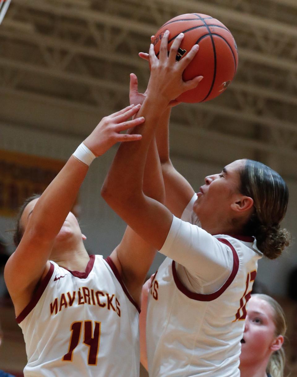 McCutcheon Mavericks guard Aubrey Miller (14) and McCutcheon Mavericks Lillie Graves (12) go for a rebound during the IHSAA girl’s basketball game against the Harrison Raiders, Friday, Dec. 15, 2023, at McCutcheon High School in Lafayette, Ind.