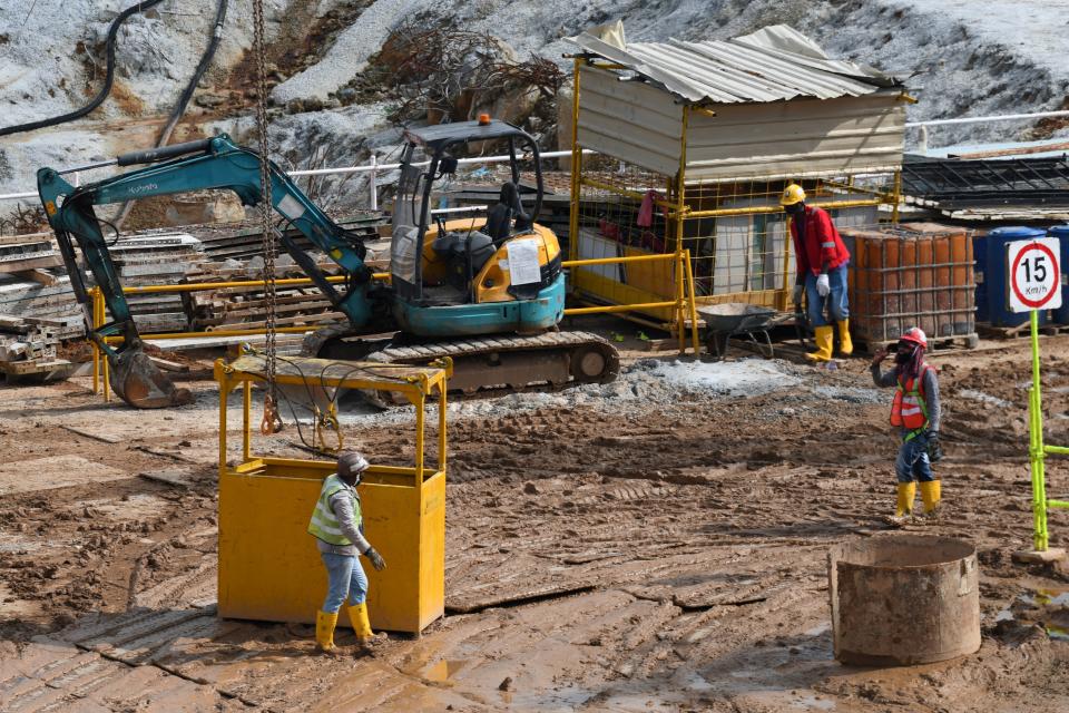 Migrant workers work at a construction site in Singapore on August 20, 2020. - About 86 per cent of foreign workers in the construction, marine and process sectors have been allowed to resume work, up from the 81 per cent announced last week, as the Ministry of Manpower announced on August 19 that all dormitories housing migrant workers were declared cleared of the COVID-19 novel coronavirus. (Photo by Roslan RAHMAN / AFP) (Photo by ROSLAN RAHMAN/AFP via Getty Images)