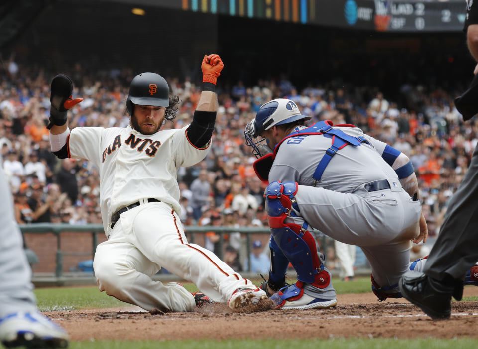 San Francisco Giants' Brandon Crawford (35) slides safe at home against Los Angeles Dodgers catcher Yasmani Grandal (9) during the second inning of a baseball game in San Francisco, Saturday, Sept. 29, 2018. (AP Photo/Jim Gensheimer)