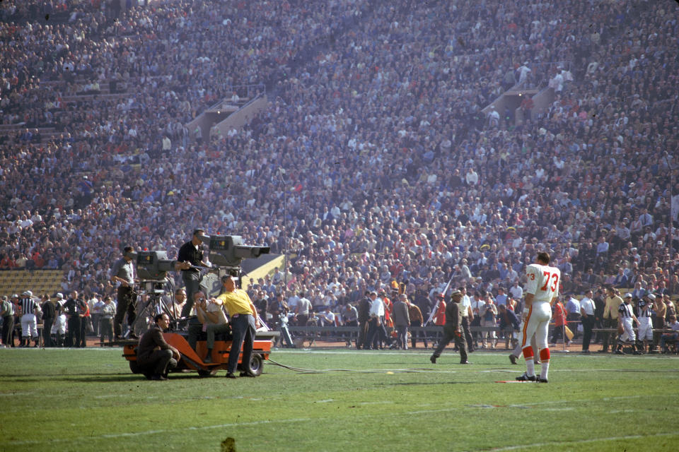 A television crew on the field filming the game