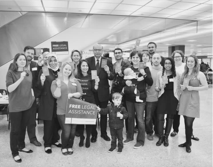 Khizr Khan poses for a picture with Dulles Justice Coalition volunteers at Washington Dulles International Airport on March 2, 2017. (Photo: Molly Hartshorn/Dulles Justice Coalition)