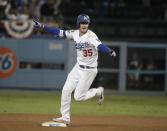 Los Angeles Dodgers' Cody Bellinger reacts after hitting a walk-off hit during the 13th inning of Game 4 of the National League Championship Series baseball game against the Milwaukee Brewers Tuesday, Oct. 16, 2018, in Los Angeles. The Dodgers won 2-1 to tie the series at 2-2. (AP Photo/Jae Hong)