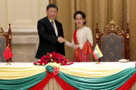 Myanmar's leader Aung San Suu Kyi, right, and Chinese President Xi Jinping, left, shake hands after the ceremony of signing a memorandum of understanding at the president house in Naypyitaw Myanmar, Saturday, Jan. 18, 2020. (Nyein Chan Naing/Pool Photo via AP)